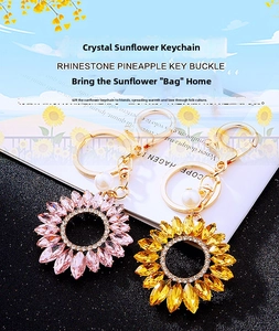 Detail of sunflower crystal keychain with sparkling pink rhinestones and pearl charm