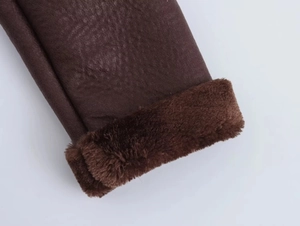 Detailed macro view of dark brown faux leather sleeve cuff with soft plush fur lining