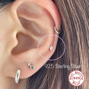 Detailed close-up of S925 sterling silver square stud earring with zircon on ear