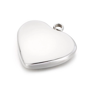 Close-up of polished silver heart pendant with reflective metal finish and top ring