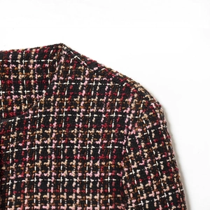 Elegant multi-color tweed jacket featuring a round neck and sophisticated woven pattern