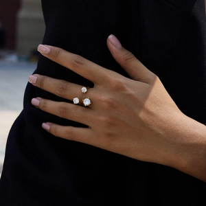 Detail of gold titanium steel ring with three brilliant zircons in a multi-stone setting