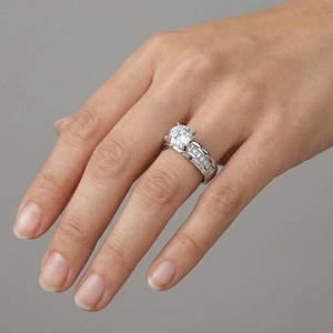 Macro detail of classic silver zircon ring with four-prong setting and side accents