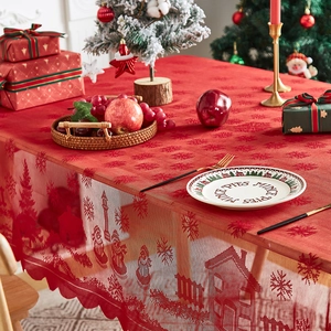 Close-up of red Christmas lace tablecloth with snowflake patterns and festive decor