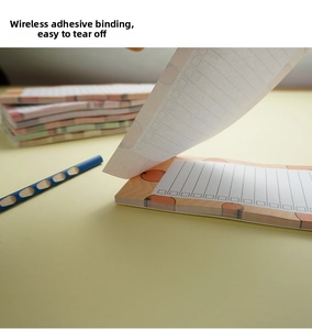 Macro view of easy-tear notepad with orange pattern and glue-bound sheets for notes