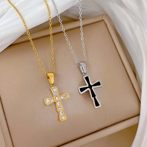 Detail of double-sided titanium cross pendant necklace with zircon and black enamel inlay