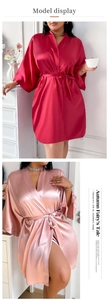 Detail showing the glossy wine red and champagne silk satin robes with elegant waist belts