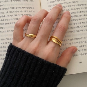 Minimalist 925 sterling silver wave rings in gold finish worn for a stacked look