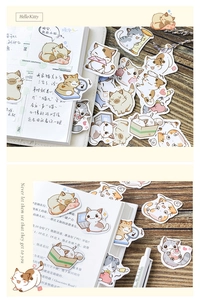 Detail of cute cartoon cat stickers applied on a journal with decorative stationery