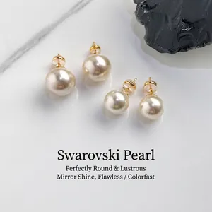 Close-up of S999 sterling silver stud earrings set featuring elegant round white pearls