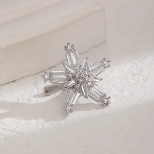 Macro shot of a sparkling silver star ear cuff with cubic zirconia and a snowflake design