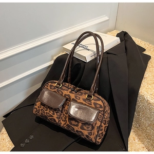 Detail of leopard print bowling bag with dual front pockets and premium gold hardware