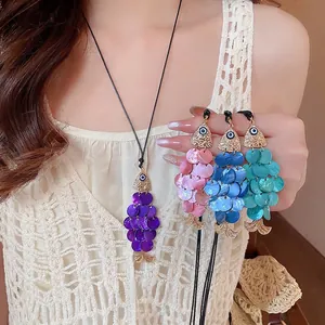 Handmade shell evil eye fish pendant necklaces with colorful iridescent finishes on black cord