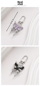 Detail view of purple and black butterfly charms with 6.5cm length measurement