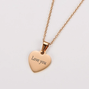 Macro shot of gold plated heart pendant with Love you engraving on a delicate chain