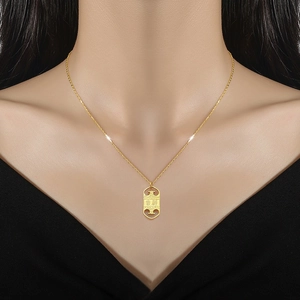 Gold titanium steel necklace with hollow rectangular auspicious pendant on a female model
