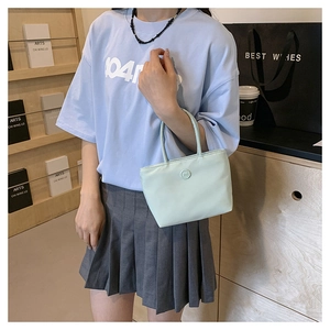 Gros plan du sac seau en nylon vert clair avec boucle circulaire m et poignées robustes