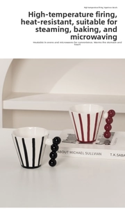 Detail of striped ceramic mugs with unique beaded handles and heat-resistant finish