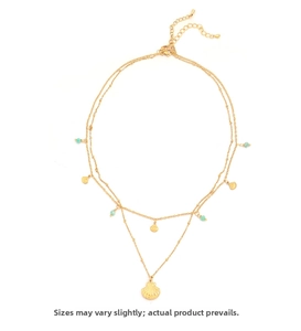 Close-up of gold double-layer necklace with shell pendant and green beads details