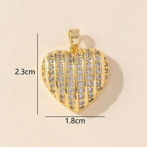 Macro view of gold heart pendant with vertical stripes and zircon crystals, 2.3cm height