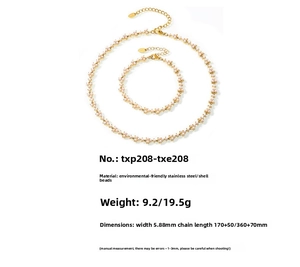 Detail of PVD gold plated stainless steel jewelry set featuring polished white shell pearls
