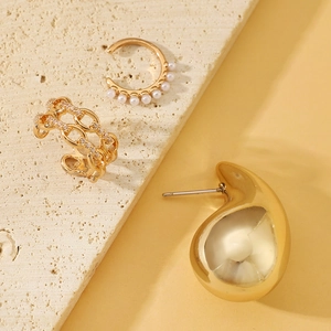 Detailed view of elegant gold-plated ear cuff set with pearls and sparkling zircons