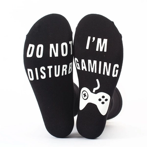 Detailed view of non-slip cotton socks with I'M GAMING text and controller icon on soles