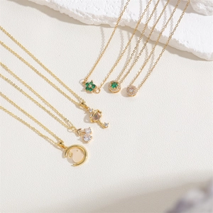 Golden pendant necklaces collection featuring emerald clover and celestial moon rabbit charms