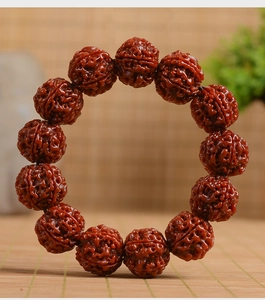 Macro shot of 13 natural rudraksha bodhi seeds with deep texture on bamboo mat