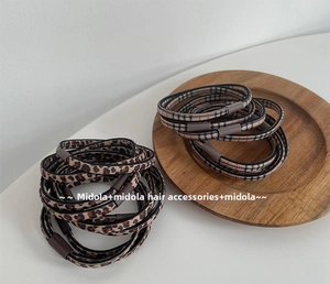 Close-up of seamless leopard print hair ties with durable cylindrical brown buckles