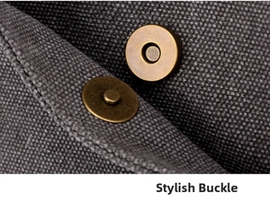 Detailed close-up of retro brass magnetic buckle on durable dark gray canvas tote bag