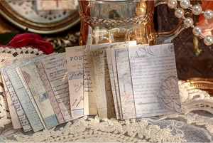 Artistic layout of vintage butterfly and floral scrapbook paper with lace and pearls