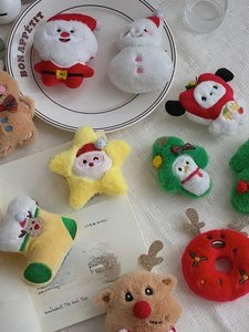 Detailed close-up of diverse Christmas plush charms including Santa and reindeer
