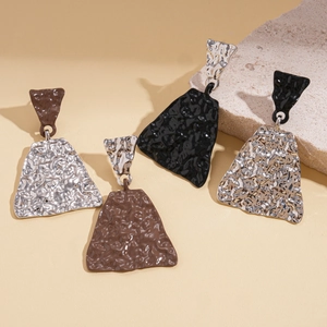 Asymmetric geometric drop earrings with metallic texture and minimalist design on stones