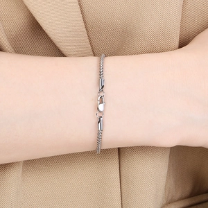 Close-up of silver steel cuban link bracelet with lobster clasp on male wrist