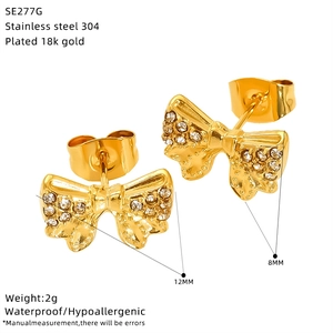 Detail view of gold bow-shaped stainless steel stud earrings with size measurements