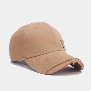 Detailed close-up of distressed brim on light khaki American retro cotton baseball cap