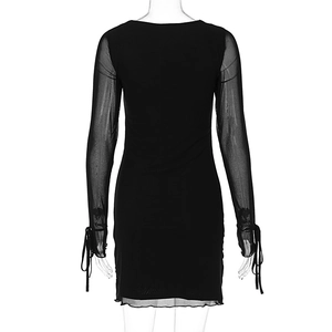 Detail of sheer mesh sleeves and adjustable drawstring cuffs on black bodycon dress