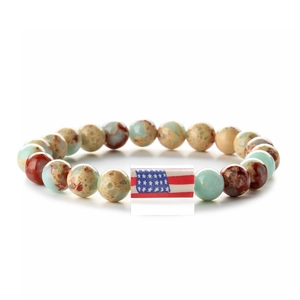 Macro detail of natural stone beaded bracelet featuring the American flag center bead