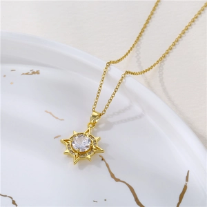 Gold stainless steel North Star pendant necklace with zircon on marble tray