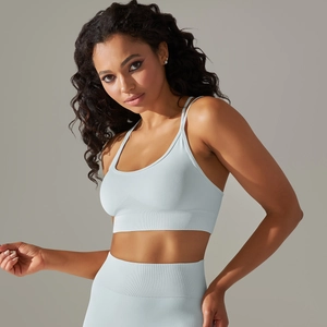 Detail of light blue seamless knitted sports bra and high-waist leggings on model