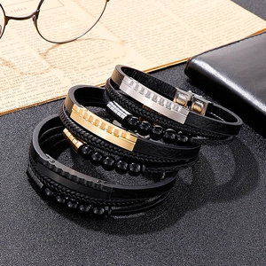 Detail view of multi-layer braided leather bracelets with stainless steel beads and charms