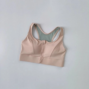 Detailed front zip closure and breathable mesh back of high-impact dusty pink sports bra