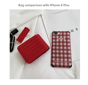 Mini red striped makeup pouch size comparison with iPhone 8 Plus for travel use