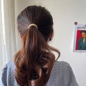 Golden brown textured hair tie shown on a ponytail for minimalist styling