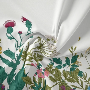 Macro detail of bohemian tapestry showing soft floral fabric texture and silky drape