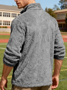 Detail of soft gray fleece jacket showing high stand collar and elastic ribbed cuffs