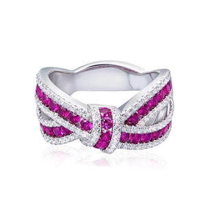 Macro detail of silver bow ring with pavé set pink rubies and sparkling white diamonds