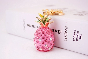 Macro detail of pineapple keychain with pink rhinestones and gold alloy hardware