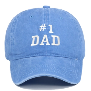 Detailed macro view of #1 DAD white embroidery on a light blue washed cotton baseball cap